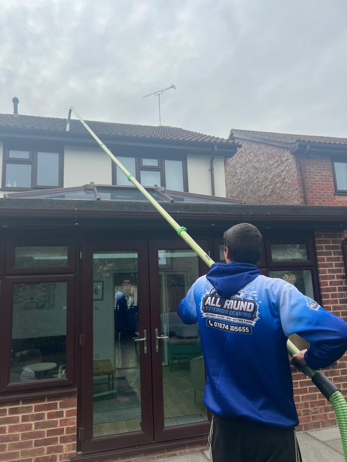 All Round Exterior Cleaning clearing gutters with professional high-reach gutter vacuum equipment
