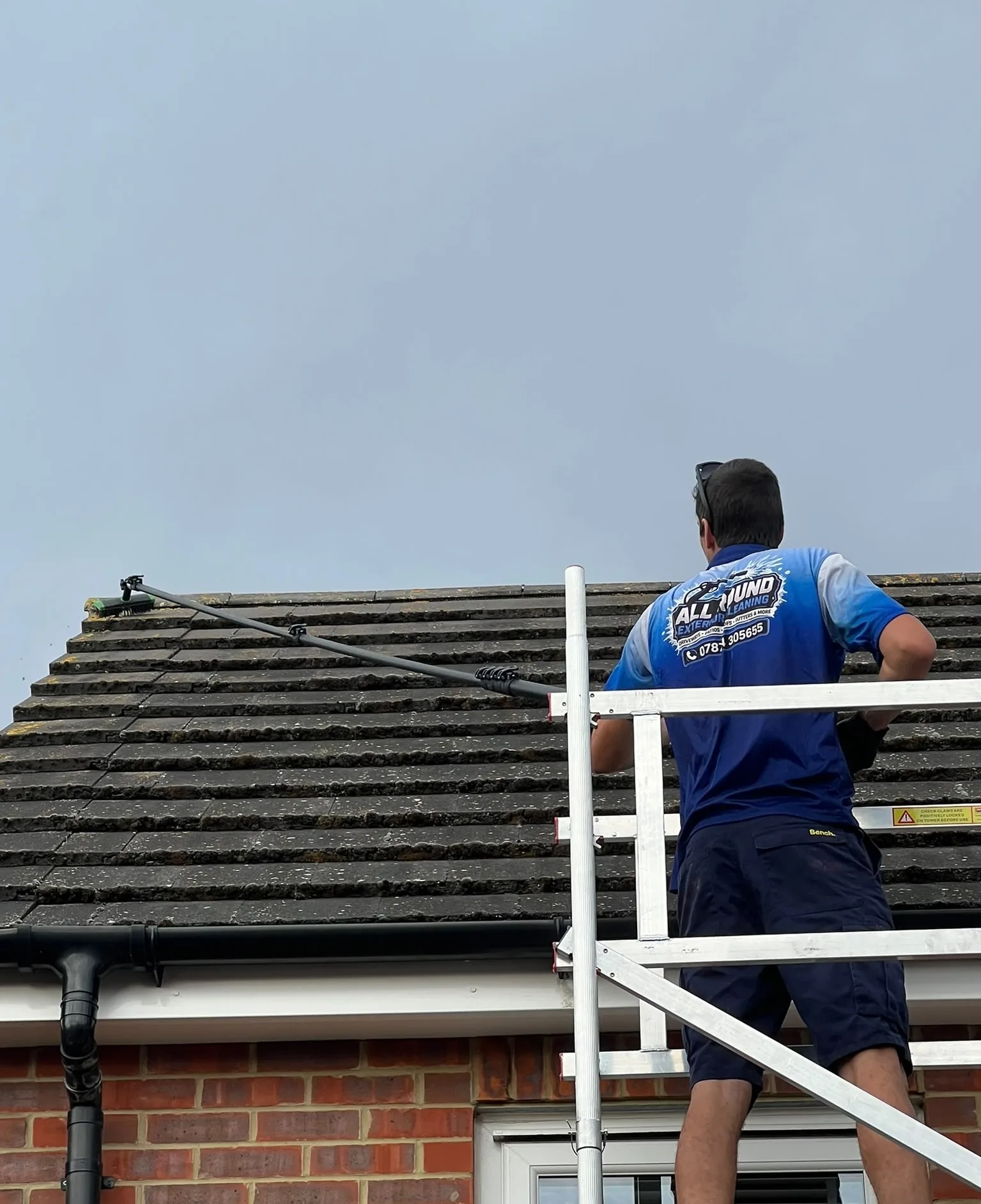 Professional roof scraping in progress